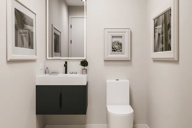a bathroom with a toilet sink and mirror