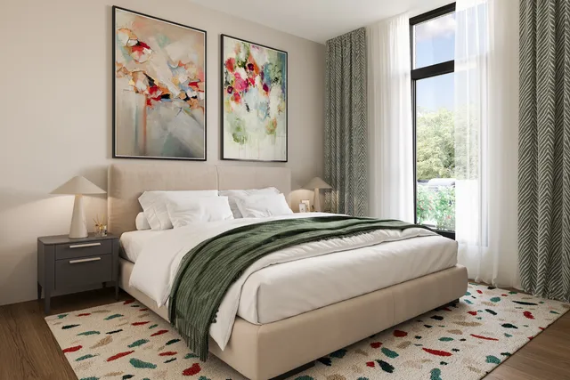 a bedroom with a bed and a painting on the wall