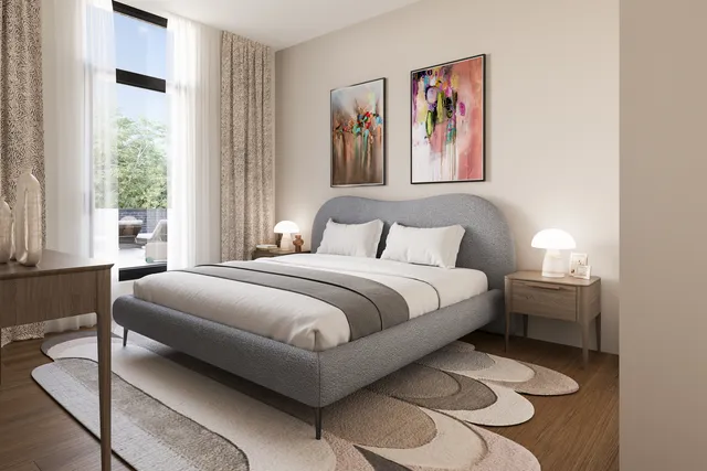 a bedroom with a bed and a painting on the wall