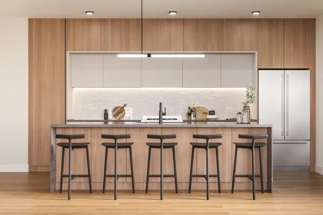 a kitchen with granite countertop a table chairs stove refrigerator and cabinets