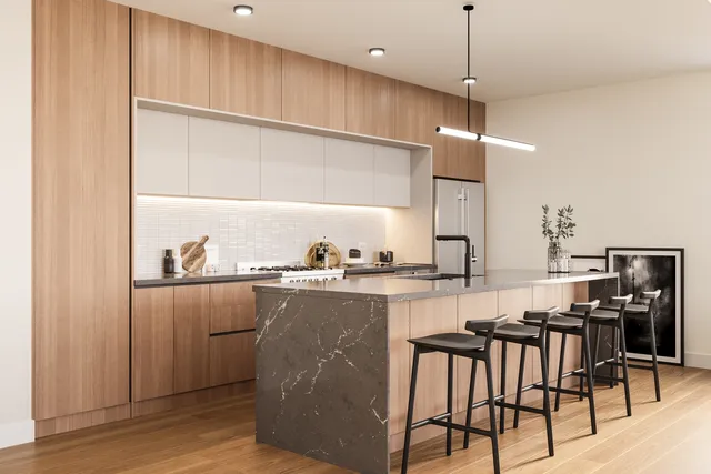 a kitchen with stainless steel appliances granite countertop a stove a sink and a refrigerator