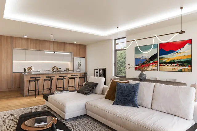 a living room with furniture a rug and a flat screen tv