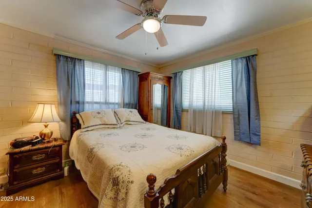 a spacious bedroom with a bed and a chandelier