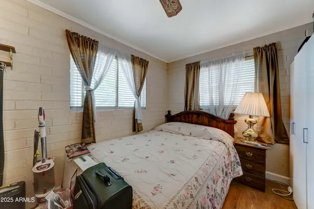 a bed sitting in a bedroom next to a window