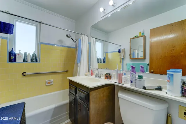 a bathroom with a sink mirror toilet and bathtub