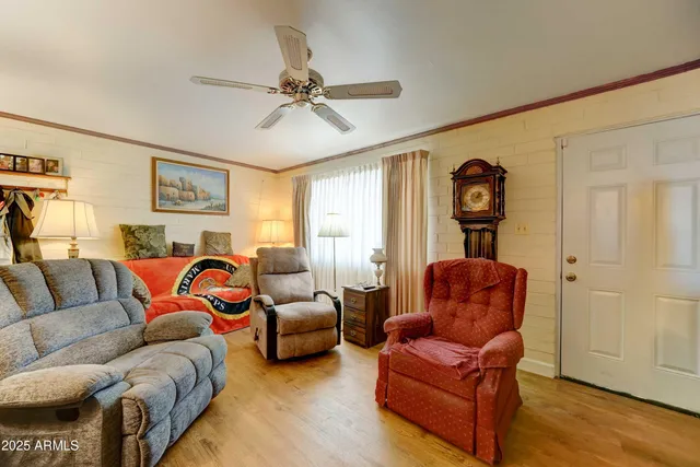 a living room with furniture a couch and wooden floor