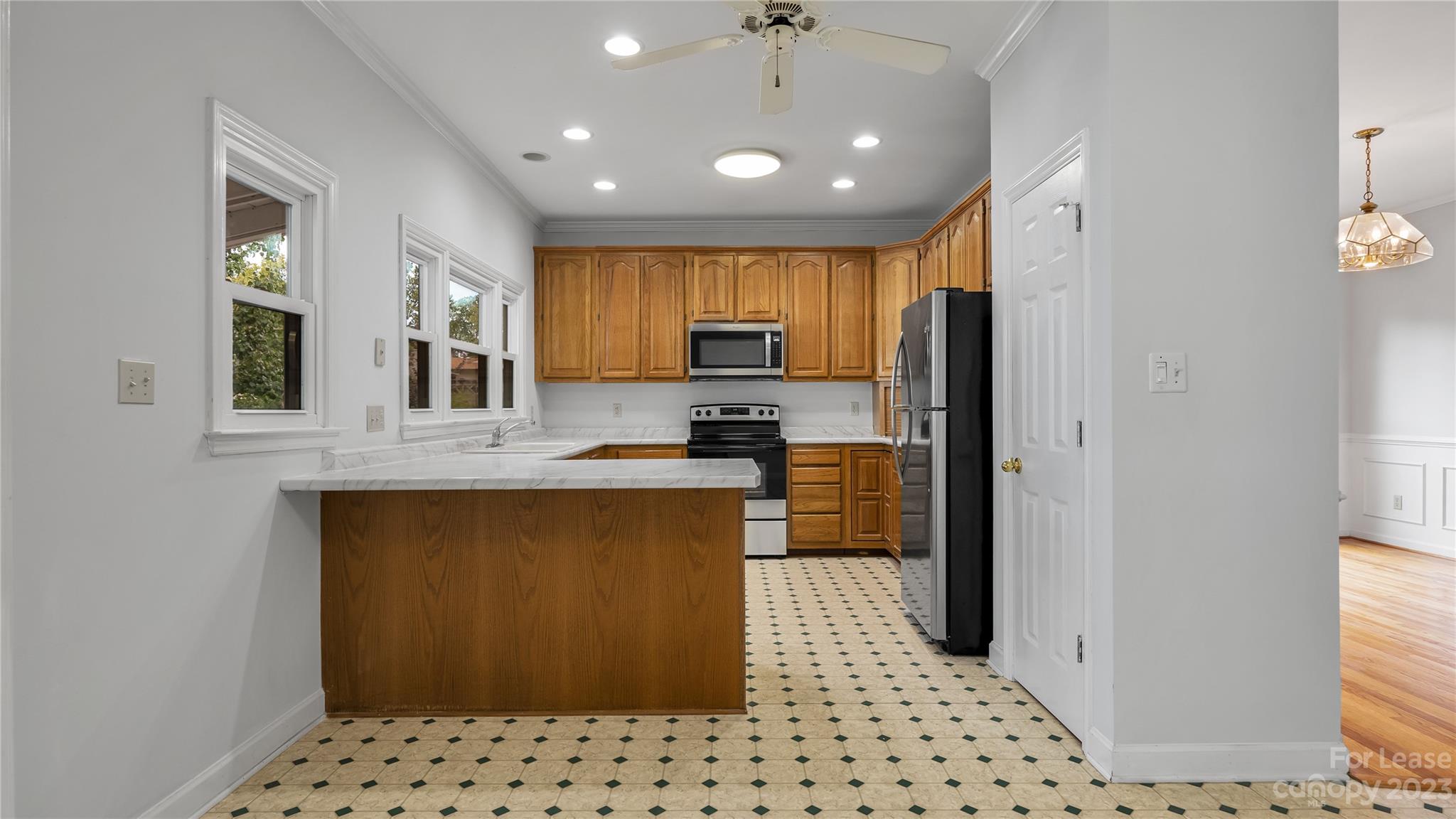 29025 Beaver Run Tega Cay, SC 29708 - Photo 11 of 40 a kitchen with stainless steel appliances kitchen island granite countertop a refrigerator and a sink