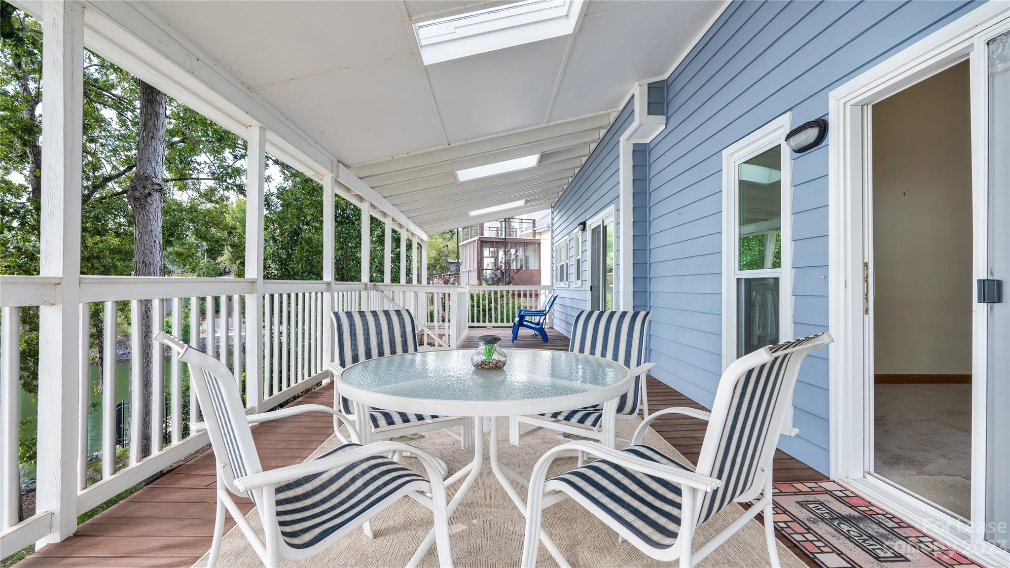 29025 Beaver Run Tega Cay, SC 29708 - Photo 35 of 40 a view of a patio with a table chairs and wooden floor