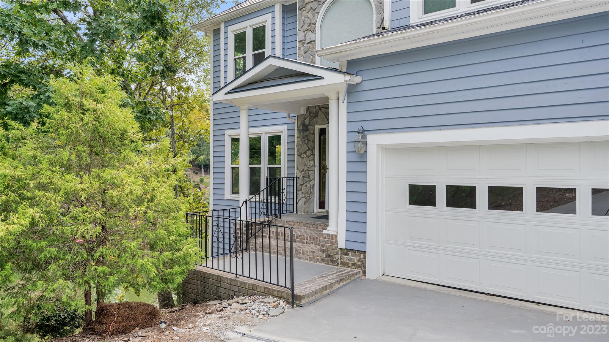 29025 Beaver Run Tega Cay, SC 29708 - Photo 4 of 40 a front view of a house with a porch