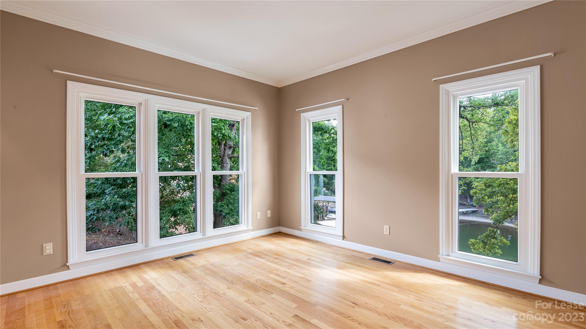29025 Beaver Run Tega Cay, SC 29708 - Photo 8 of 40 a view of an empty room with wooden floor and a window