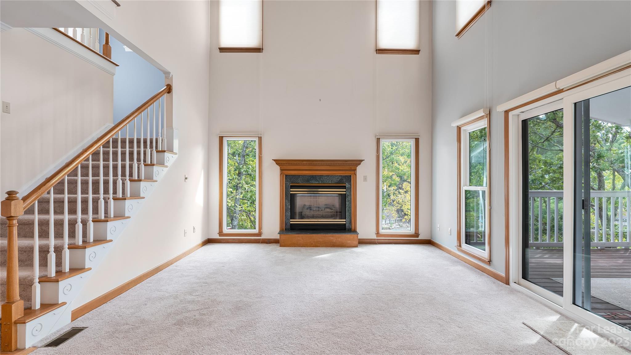 29025 Beaver Run Tega Cay, SC 29708 - Photo 9 of 40 a view of an empty room with wooden floor fireplace and a window