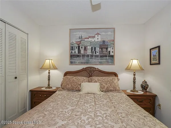 a bedroom with a bed and a lamp