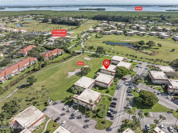 an aerial view of a houses with a yard