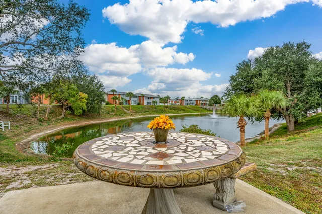 a living room with furniture and two windows