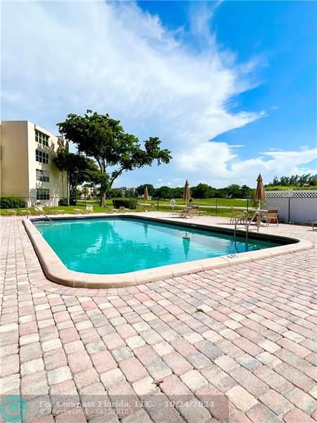 9495 Evergreen Place, Unit 405 Davie, FL 33324 - Photo 11 of 17 a view of a swimming pool and lake