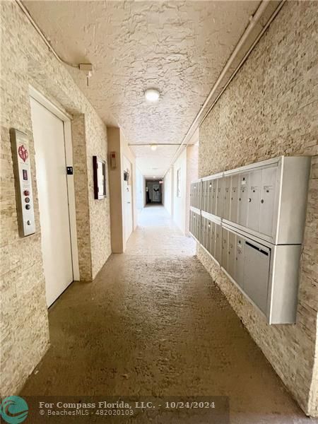 9495 Evergreen Place, Unit 405 Davie, FL 33324 - Photo 7 of 17 a view of a hallway with white walls