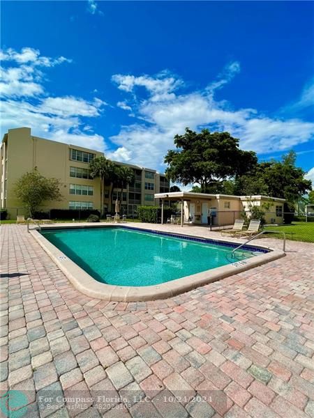 9495 Evergreen Place, Unit 405 Davie, FL 33324 - Photo 10 of 17 a view of a swimming pool with a yard
