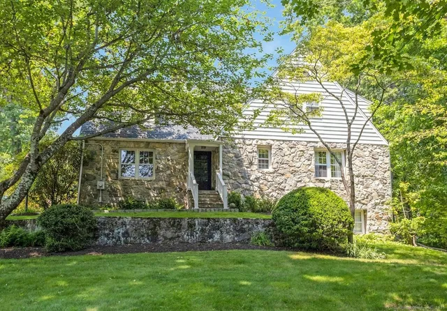 a front view of a house with a garden