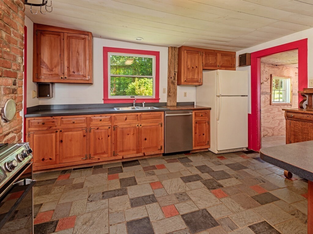 194 Wales Road Brimfield, MA 01010 - Photo 9 of 42 a kitchen with stainless steel appliances granite countertop a stove a sink and a refrigerator