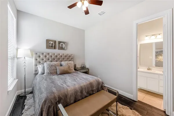 a bedroom with a large bed and a chandelier