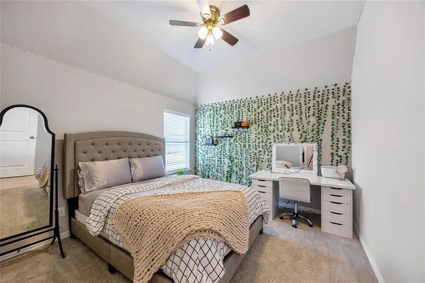 a bedroom with a bed a desk and chair
