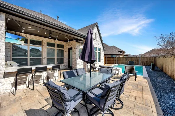 a backyard of a house with table and chairs