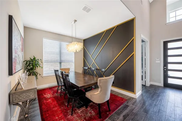 a dining room with furniture window and wooden floor