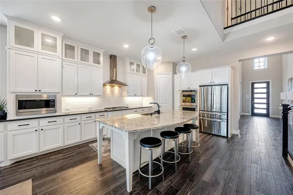a kitchen with center island and stainless steel appliances
