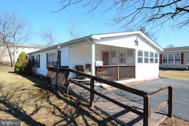 a view of a house with pool and sitting area