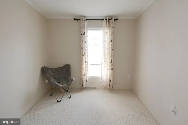 a room with a chair and a window