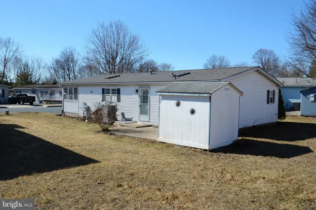 a view of a patio with table and chairs under an umbrella