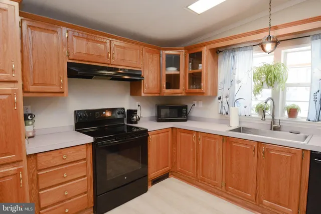 a kitchen with stainless steel appliances granite countertop wooden cabinets and a stove