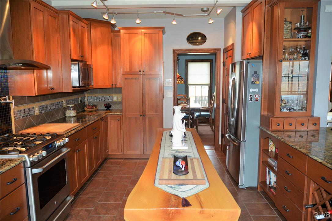 1983 Snyder Road Ulster, PA 18850 - Photo 19 of 50 a kitchen with stainless steel appliances granite countertop a refrigerator a stove and a wooden cabinets