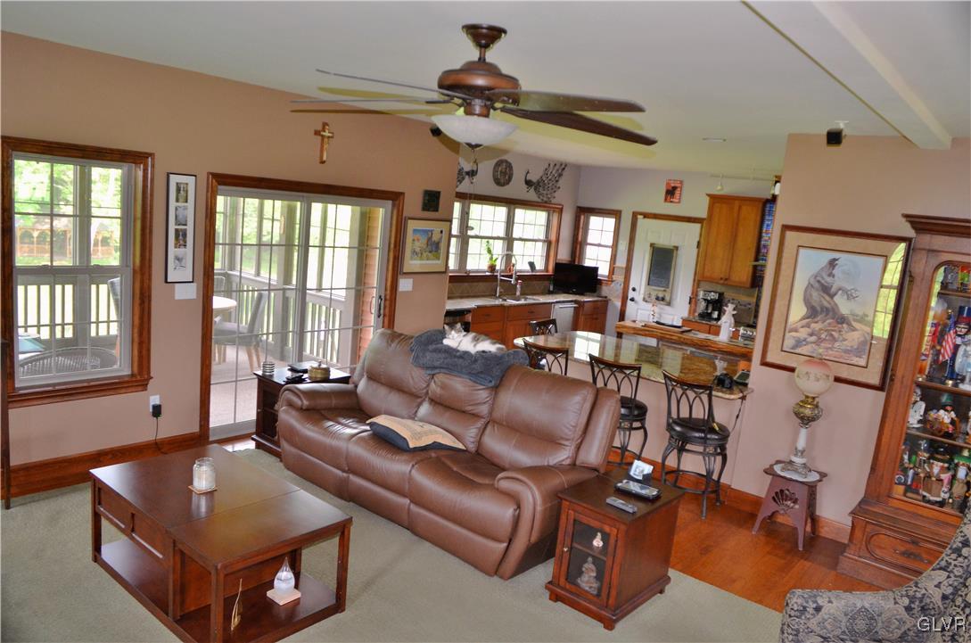1983 Snyder Road Ulster, PA 18850 - Photo 21 of 50 a living room with furniture a flat screen tv and a large window