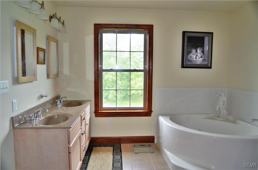 1983 Snyder Road Ulster, PA 18850 - Photo 28 of 50 a bathroom with a tub a sink and a window