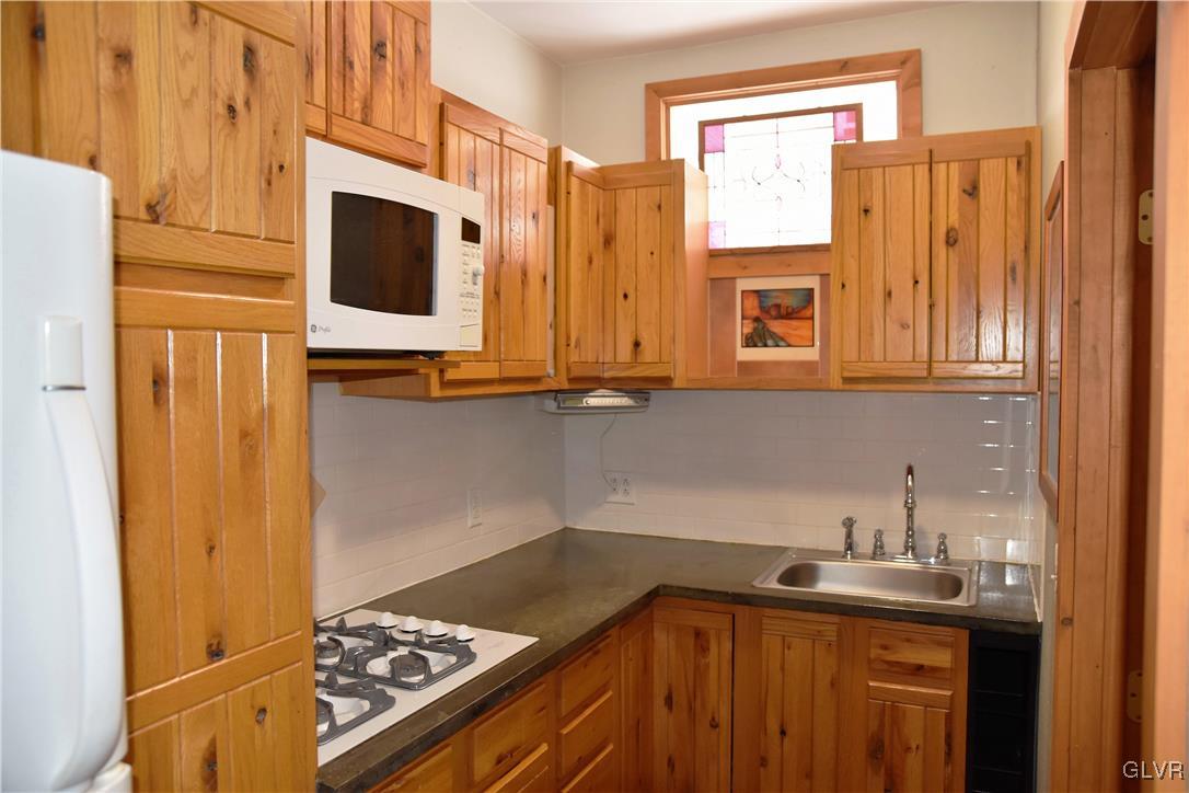 1983 Snyder Road Ulster, PA 18850 - Photo 45 of 50 a kitchen with stainless steel appliances a stove a microwave and sink