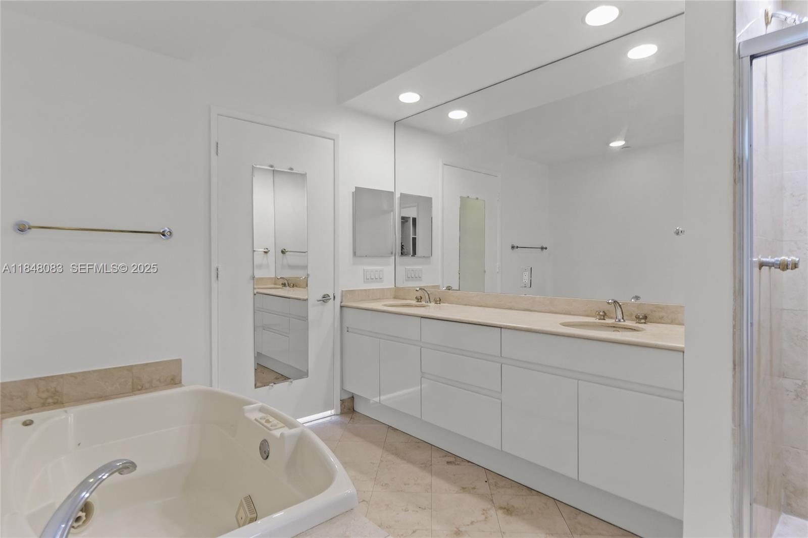 703 Crandon Boulevard, Unit PH3 Key Biscayne, FL 33149 - Photo 14 of 40 a bathroom with a tub sink and mirror