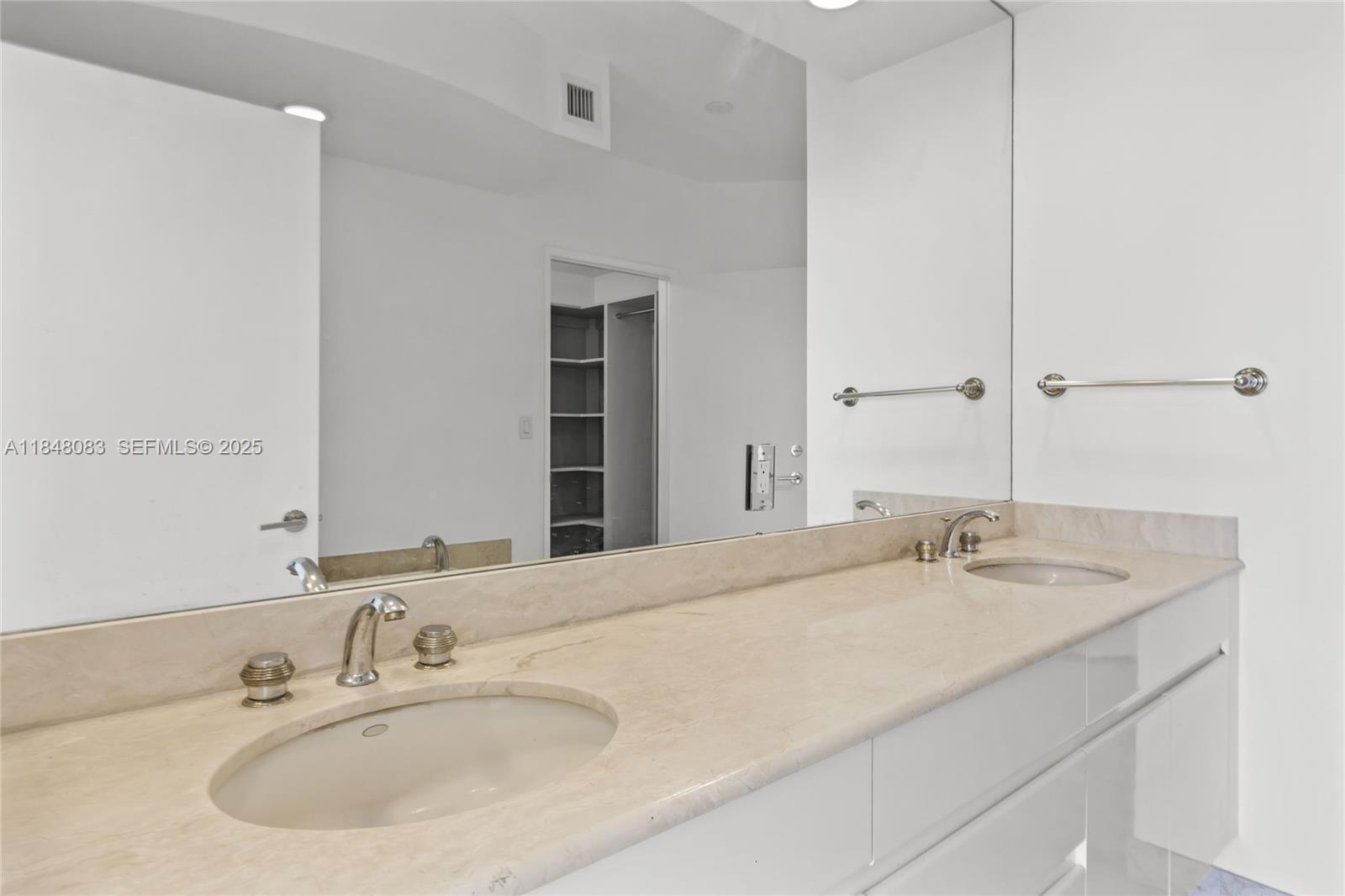 703 Crandon Boulevard, Unit PH3 Key Biscayne, FL 33149 - Photo 15 of 40 a bathroom with a sink and a mirror