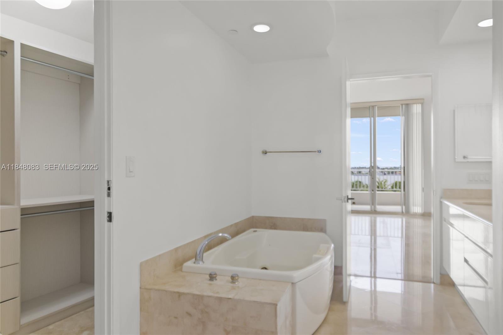 703 Crandon Boulevard, Unit PH3 Key Biscayne, FL 33149 - Photo 16 of 40 a bathroom with a tub sink and vanity