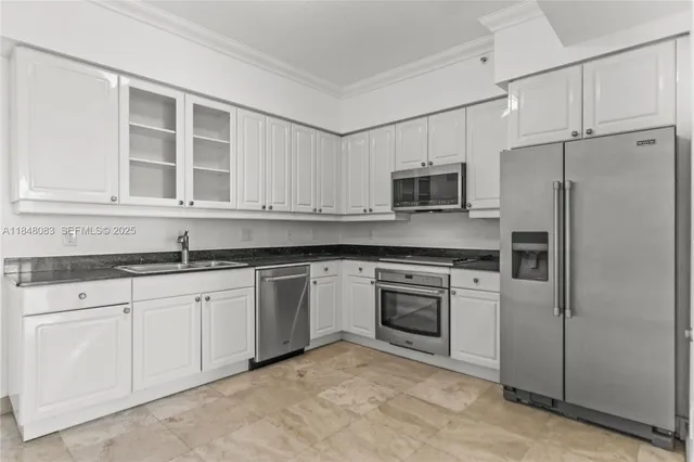 a kitchen with granite countertop cabinets stainless steel appliances and a sink