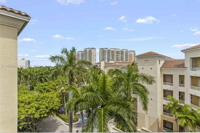 a view of a multi story residential apartment building with yard and plants