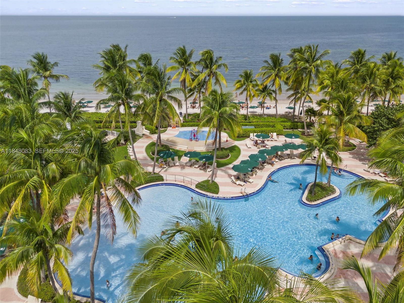 703 Crandon Boulevard, Unit PH3 Key Biscayne, FL 33149 - Photo 5 of 40 a view of swimming pool with a yard