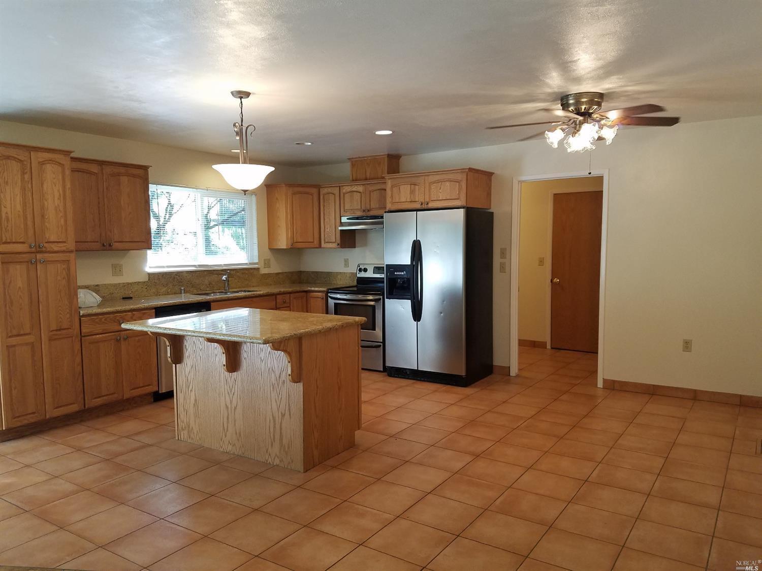 1710 Wildwood Road Ukiah, CA 95482 - Photo 1 of 1 Bright kitchen, granite counters, under mount ss sink, with ss appliances and dishwasher, and room for dine in table.