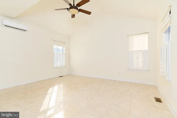 a workspace with furniture wooden floor and a flat screen tv