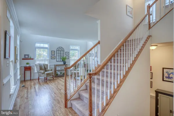 a view of dining room with wooden floor and stairs