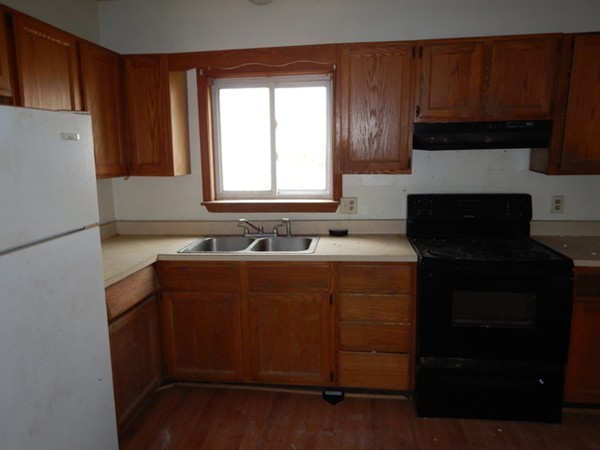 31-33 Aspen Street Ware, MA 01082 - Photo 21 of 31 a kitchen with a refrigerator stove and cabinets