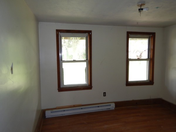 31-33 Aspen Street Ware, MA 01082 - Photo 23 of 31 an empty room with wooden floor and windows