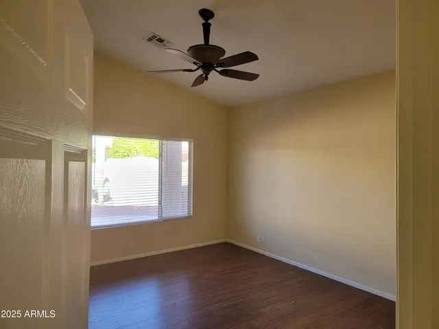 a view of an empty room and wooden floor