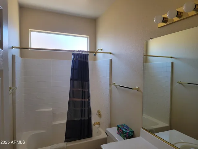 a bathroom with a shower and a sink