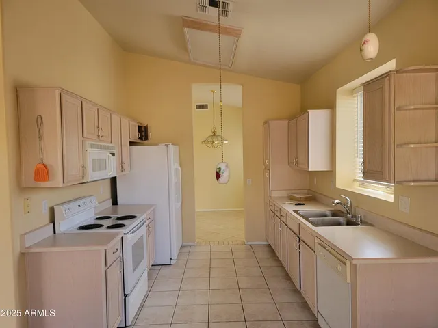 a kitchen with a sink stove and refrigerator